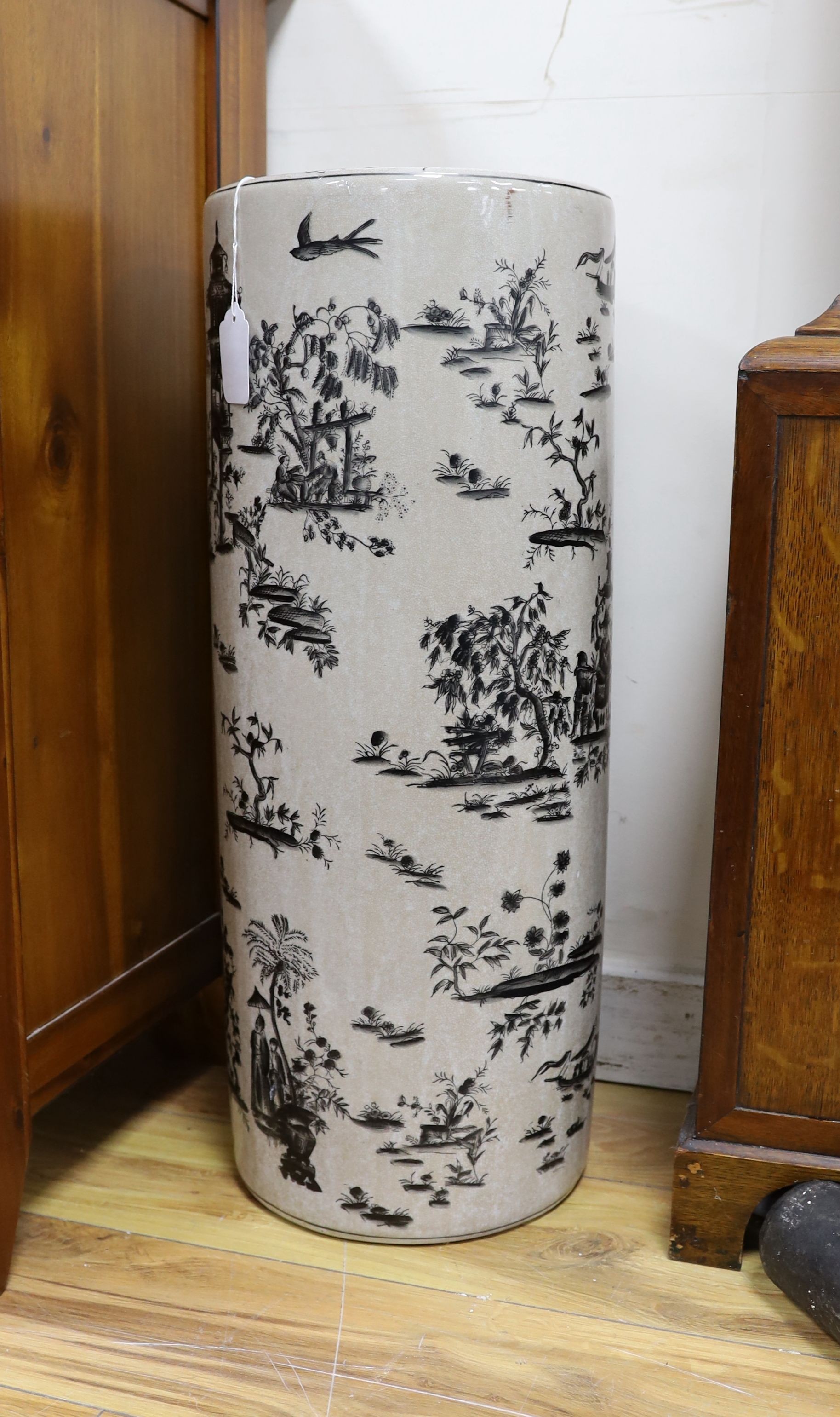 A Chinese style blue and white lidded baluster vase and a cylindrical stick stand (2)
